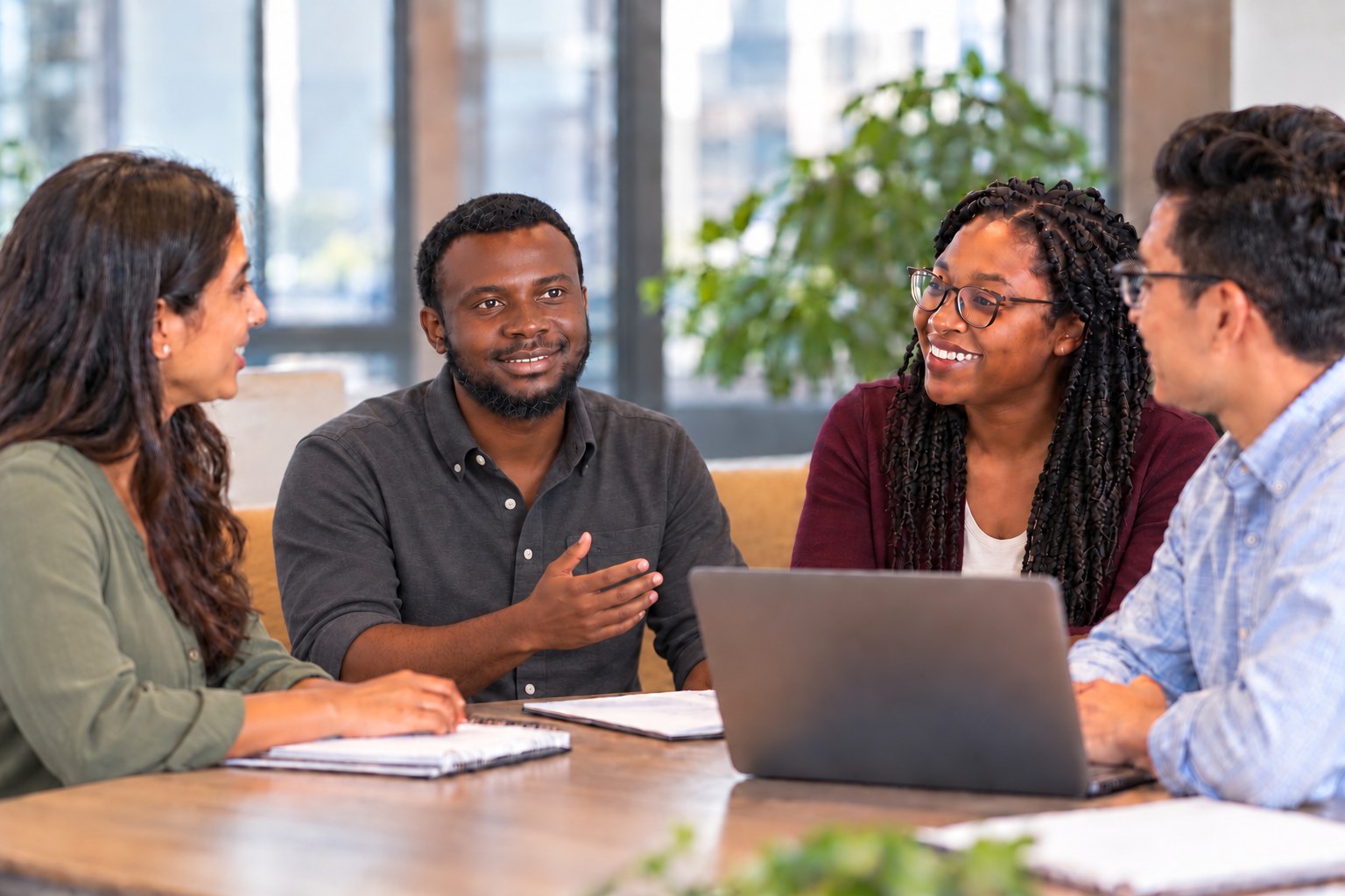 Illustrative scene of Joshua Awua in a charcoal shirt with rolled sleeves discussing research with a group